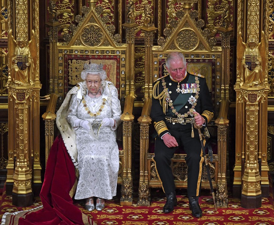 Britain&#039;s Queen Elizabeth II, with Prince Charles, delivers the Queen&#039;s Speech at the official State Opening of Parliament in London, Monday Oct. 14, 2019. (Victoria Jones/Pool via AP)