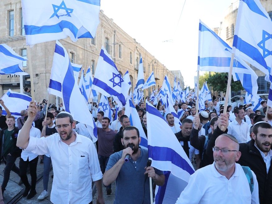 epa09898931 Israeli right wing activists hold the Israeli national flags in a protest against recent attacks against Jews in Jerusalem, near the old city of Jerusalem, 20 April 2022. Israeli police ba ...