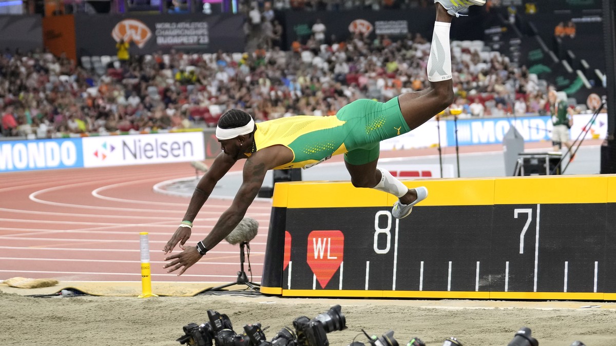 Jamaican flies head first onto the sand in a spectacular long jump