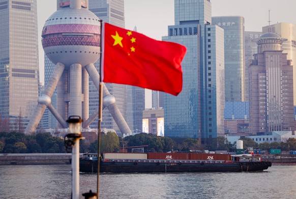 epa12647824 Cargo ships sail on Huangpu River, in Shanghai, China, 13 January 2026 (issued 14 January 2026). According to the General Administration of Customs, Chinas trade surplus reached a record  ...