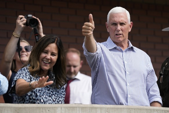 Republican presidential candidate former Vice President Mike Pence and his wife Karen gesture to fairgoers at the Iowa State Fair, Thursday, Aug. 10, 2023, in Des Moines, Iowa. (AP Photo/Charlie Neibe ...