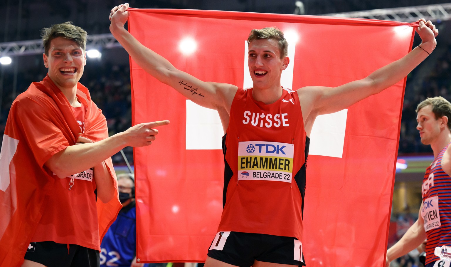 epa09836624 Simon Ehammer (C) of Switzerland celebrates next to compatriot Andri Oberholzer (L) after winning the silver medal in the Heptathlon event at the IAAF World Athletics Indoor Championships  ...