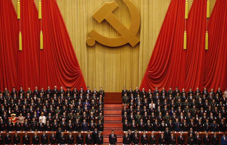 FILE - Chinese President Xi Jinping, front row center, stands with his cadres during the Communist song at the closing ceremony for the 19th Party Congress at the Great Hall of the People in Beijing o ...