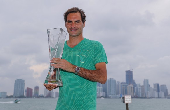 epa05885184 Roger Federer of Switzerland poses with the winner&#039;s trophy, with the downtown Miami skyline behind him, after defeating Rafael Nadal of Spain during the men&#039;s singles final matc ...