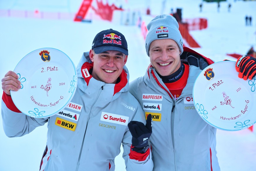 Winner Switzerland's Marco Odermatt, right, and fellow-countryman second placed Franjo von Allmen pose with their trophies of a men's World Cup super-G, in Kitzbuehel, Friday, Jan. 23, 2026. ...