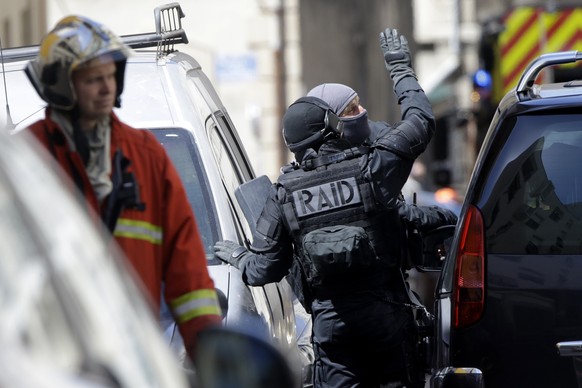 Hooded elite police officers cordon off a street during searches in Marseille, southern France, Tuesday, April 18, 2017. Security concerns shook France&#039;s presidential campaign Tuesday as authorit ...