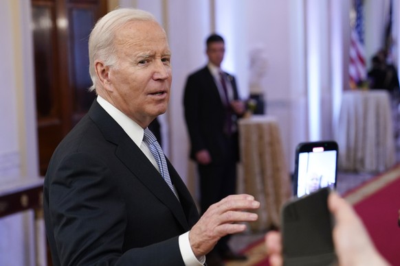 FILE - President Joe Biden talks with reporters after speaking in the East Room of the White House in Washington, Jan 20, 2023. A new poll shows that more U.S. adults disapprove than approve of the wa ...