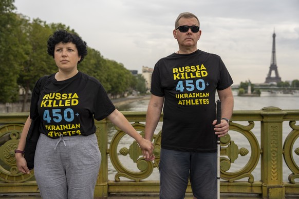 People attend a flash mob to highlight the plight of hundreds of Ukrainian athletes and coaches, both amateur and professional, who were killed as a result of Russia&#039;s war in Ukraine in Paris, Fr ...