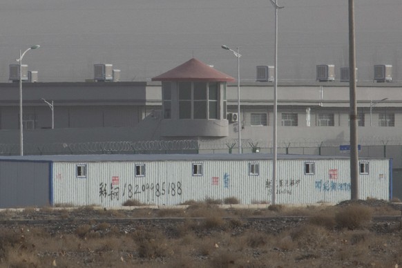 In this Monday, Dec. 3, 2018, photo, a guard tower and barbed wire fences are seen around a facility in the Kunshan Industrial Park in Artux in western China&#039;s Xinjiang region. People in touch wi ...