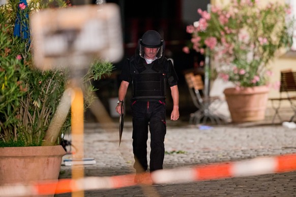 epa05439814 A police officer operates on the scene of an explosion in Ansbach, Germany, 25 July 2016. A man was killed and 12 others were injured in an explosion in Franconia Ansbach late on 24 July.  ...