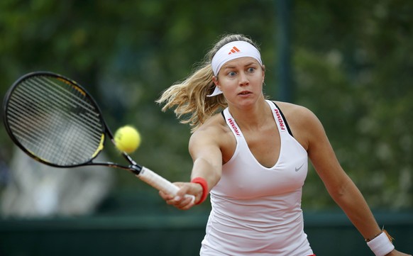 Stefanie Voegele of Switzerland returns a forehand to Anna-Lena Friedsam of Germany during their women&#039;s singles match at the French Open tennis tournament at the Roland Garros stadium in Paris M ...