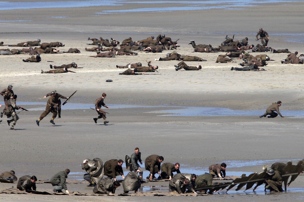 Actors perform on the beach during filming a scene for the film, "Dunkirk," in Dunkirk, northern France, Thursday, May 26, 2016. The film, directed by Christopher Nolan, tells the story of t ...