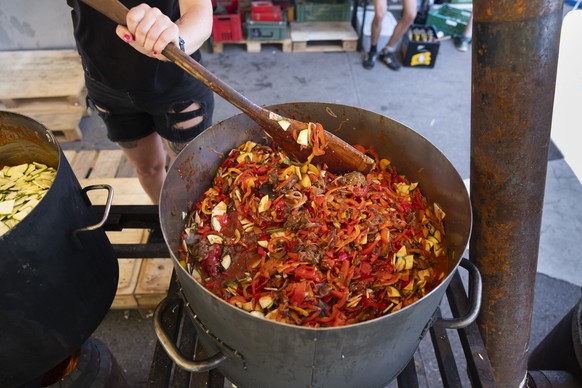 A staff worker in the vegan kitchen cooks ratatouille during the international anti-authoritarian gathering Anarchy 2023 in St-Imier, Switzerland, on Wednesday, July 19, 2023. The gathering takes plac ...