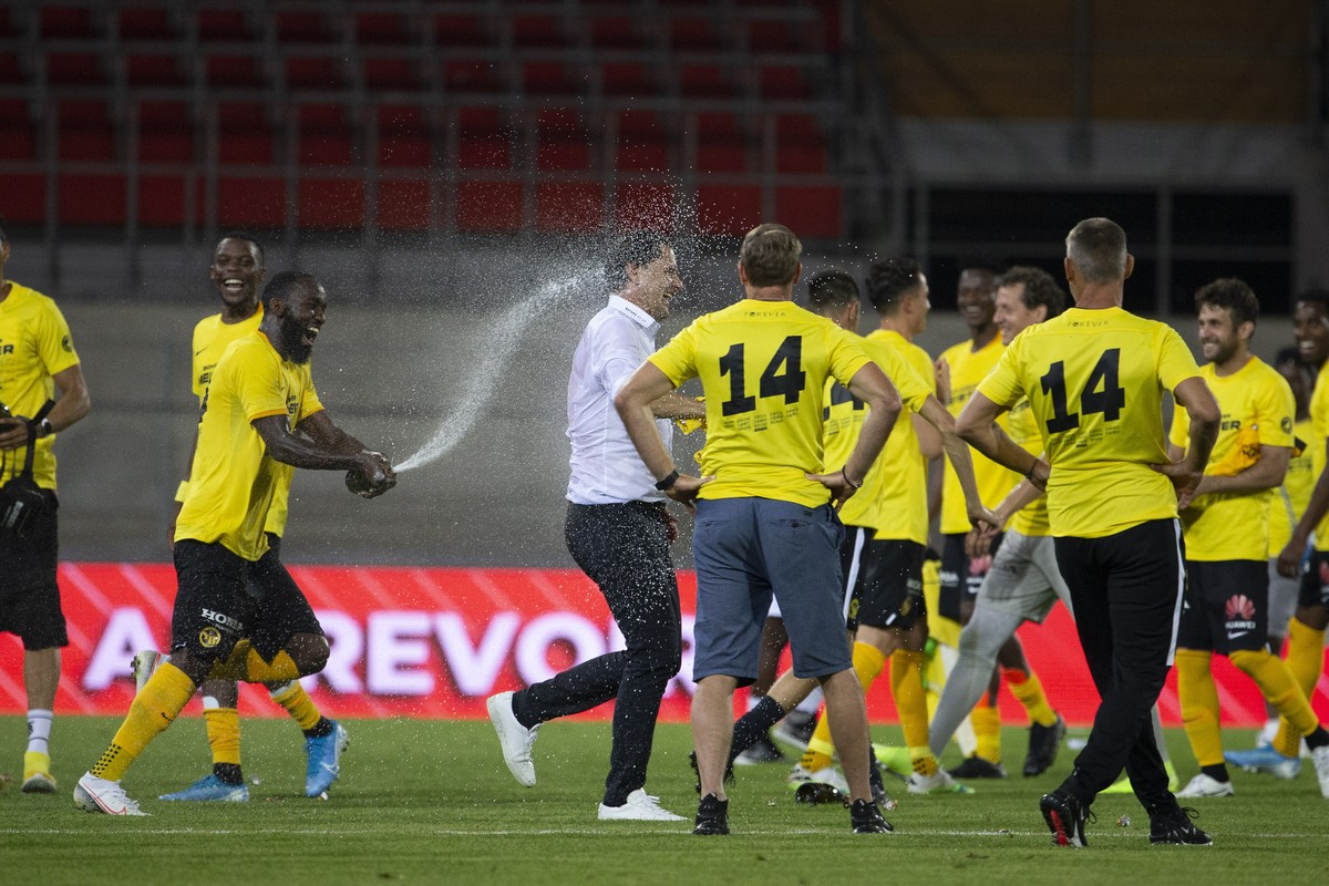 Young Boys' players celebrate title as Swiss champion with of sparkling wine, after the Super League soccer match between FC Sion and BSC Young Boys, at the Stade de Tourbillon stadium, in Sion,  ...