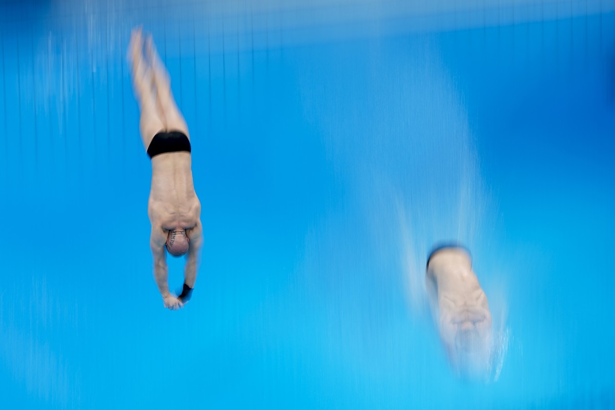 Russian Olympic Committee's Evgenii Kuznetsov and Nikita Shleikher compete during men's synchronised 3-meter springboard at the 2020 Summer Olympics, Monday, July 26, 2021, in Tokyo, Japan.  ...
