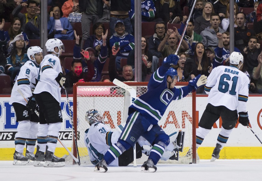 Vancouver Canucks&#039; Bo Horvat, front, celebrates a goal by Sven Baertschi, not seen, as San Jose Sharks&#039; Joe Pavelski (8), Marc-Edouard Vlasic (44), goalie Martin Jones (31) and Justin Braun  ...