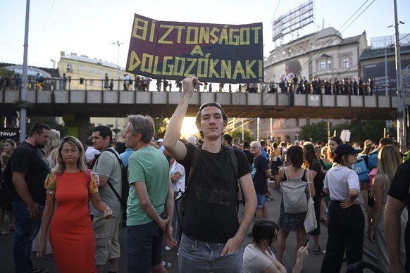 epa10069646 Following the call of the oppositional Momentum party demonstrators protest against the changes in the small business tax (kata) in central Budapest, Hungary, 13 July 2022. A law modifying ...
