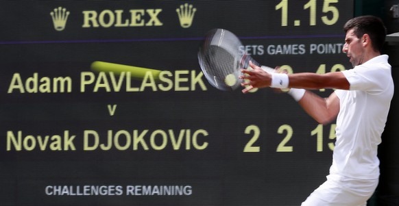 epa06070019 Novak Djokovic of Serbia returns to Adam Pavlasek of the Czech Republic in their second round match during the Wimbledon Championships at the All England Lawn Tennis Club, in London, Brita ...