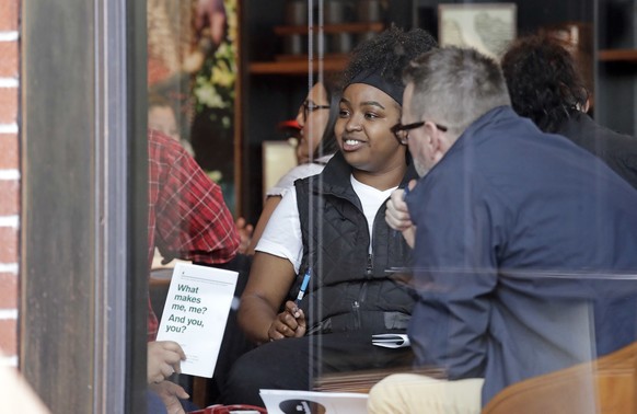 People are seen meeting inside the ground floor, closed Starbucks Reserve at the company&#039;s headquarters during employee anti-bias training, Tuesday, May 29, 2018, in Seattle. Starbucks closed mor ...