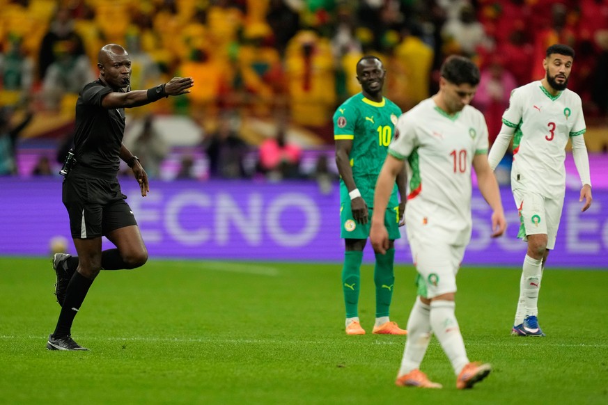 DR Congo's referee Jean-Jacques Ndala calls a penalty after a review during the Africa Cup of Nations final soccer match between Senegal and Morocco, in Rabat, Morocco, Sunday, Jan. 18, 2026. (AP ...