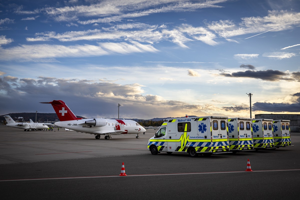 Ambulances are lined up while an aircraft of the Swiss Air Rescue Service Rega taxis to transport injured children and their relatives at Zurich Airport, Switzerland, on Friday, October 24, 2025. As p ...