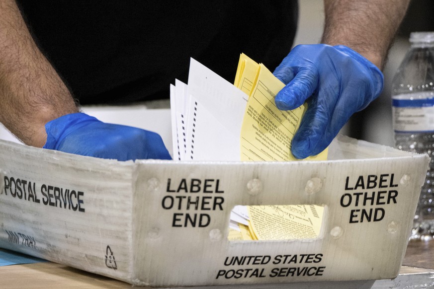 Fulton County Georgia elections workers process absentee ballots for the Senate runoff election in Atlanta on Tuesday, Jan. 5, 2021. Georgia&#039;s two Senate runoff elections on Tuesday will determin ...