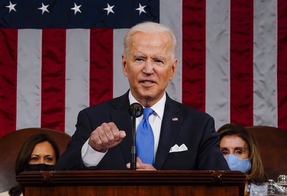 epa09166681 US President Joe Biden addresses a joint session of Congress, with Vice President Kamala Harris and House Speaker Nancy Pelosi (D-Calif.) sitting behind him, at the Capitol in Washington,  ...