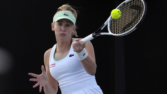 Jil Teichmann of Switzerland plays a forehand return to Petra Martic of Croatia during their first round match at the Australian Open tennis championships in Melbourne, Australia, Monday, Jan. 17, 2022. (AP Photo/Simon Baker)
Jil Teichmann