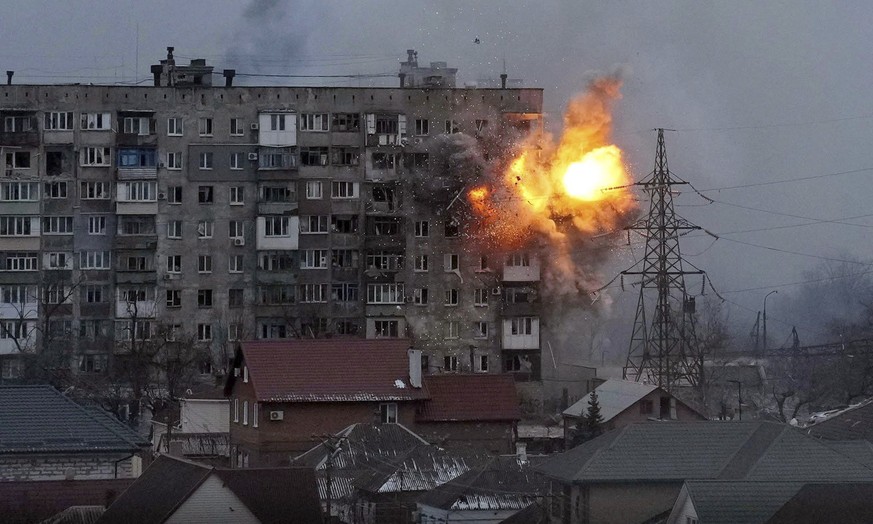 FILE - An explosion erupts from an apartment building after a Russian army tank fired on it in Mariupol, Ukraine, March 11, 2022. The image is part of the documentary &quot;20 Days in Mariupol.&quot;  ...