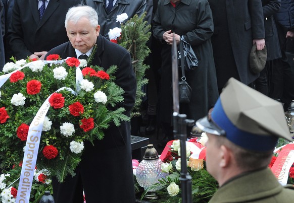 The ruling party Law and Justice leader and twin brother of the former Polish President Lech Kaczynski, Jaroslaw Kaczynski, left, attends a ceremony at the Powazki cemetery to mark the sixth anniversa ...