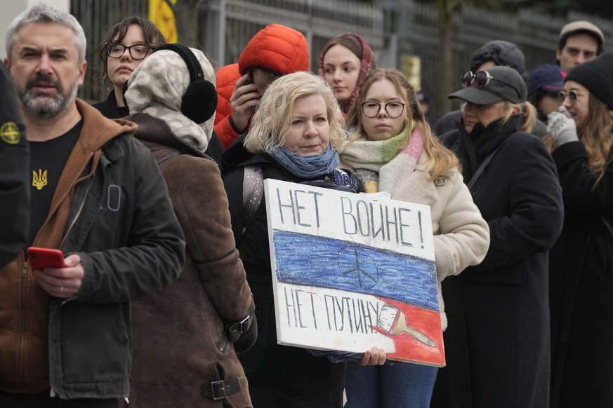 Russians queue at the Russian Embassy in Warsaw, Poland, Sunday, March 17, 2024 to cast their vote on the last day of the three-day presidential elections. Russians at home and abroad are heading to t ...