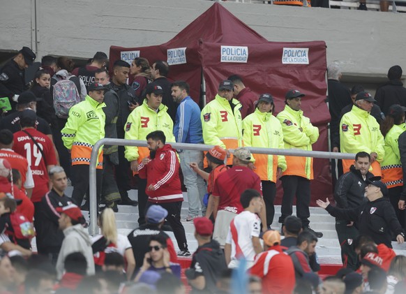 Police officers and security staff members secure an area where an accident involving a spectator who fell to his death, during a local tournament soccer match between River Plate and Defensa y Justic ...