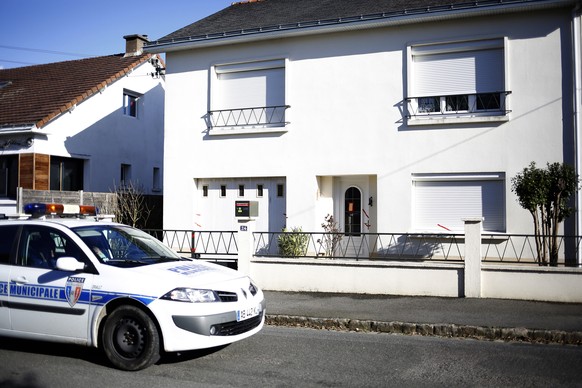 This photo dated Tuesday, Feb. 28, 2017 shows a police car parked outside the house belonging to the missing Troadec family in Orvault, near Nantes, western France. Forensics officers locked down a ne ...