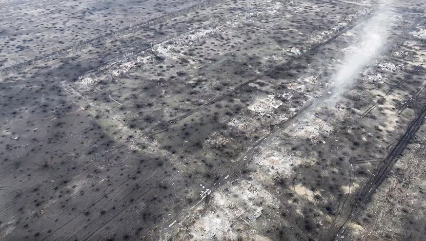 In this screen grab from a video taken on Wednesday, Dec. 6, 2023 by the BUAR done unit of the 110th Mechanized Brigade, an ariel view on the ground covered with craters from artillery shell explosion ...