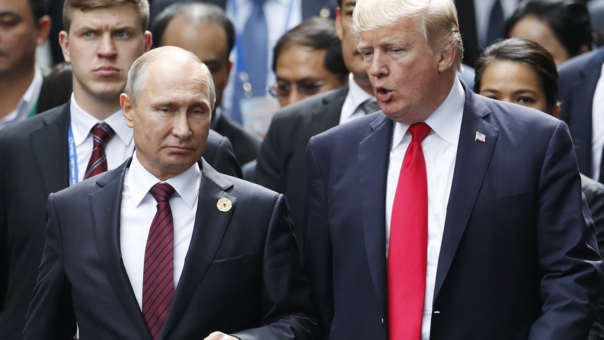 U.S. President Donald Trump and Russia&#039;s President Vladimir Putin talk during the family photo session at the APEC Summit in Danang, Saturday, Nov. 11, 2017. President Trump stood before a summit ...