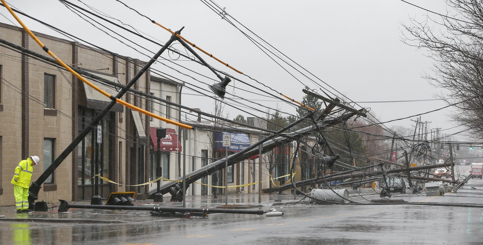 epa06575532 Wind knocks down power poles onto Arsenal Street in Watertown, Massachusetts, USA 02 March 2018. A winter storm headed up the eastern seacoast is projected to bring rain, winds up to 60 mp ...