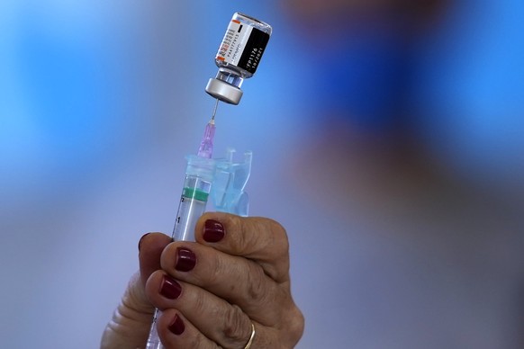 A health worker prepares a shot of the Pfizer COVID-19 vaccine at a community health center in Brasilia, Brazil, Sunday, Jan. 16, 2022. Brasilia started the COVID-19 vaccination of children between ag ...