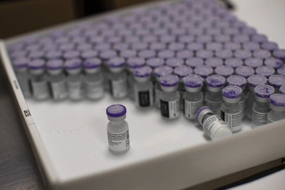 FILE - In this Monday, Jan. 4, 2021 file photo, frozen vials of the Pfizer/BioNTech COVID-19 vaccine are taken out to thaw, at the MontLegia CHC hospital in Liege, Belgium. The European Commission has ...