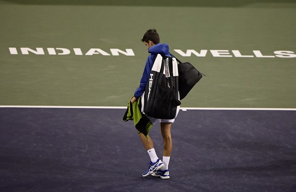 Novak Djokovic, of Serbia, walks off the court during a rain break in his match against Philipp Kohlschreiber, of Germany, at the BNP Paribas Open tennis tournament Monday, March 11, 2019, in Indian W ...
