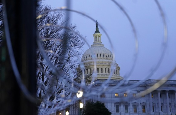 The U.S. Capitol dome is seen past security fencing and barbed wire in Washington, Saturday, Jan. 16, 2021, as preparations take place for President-elect Joe Biden's inauguration ceremony. (AP P ...