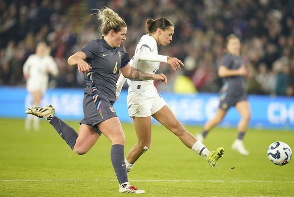 England&#039;s Millie Bright, left, and Switzerland&#039;s Iman Beney battle for the ball during the international women&#039;s friendly soccer match between England and Switzerland at Bramall Lane, S ...