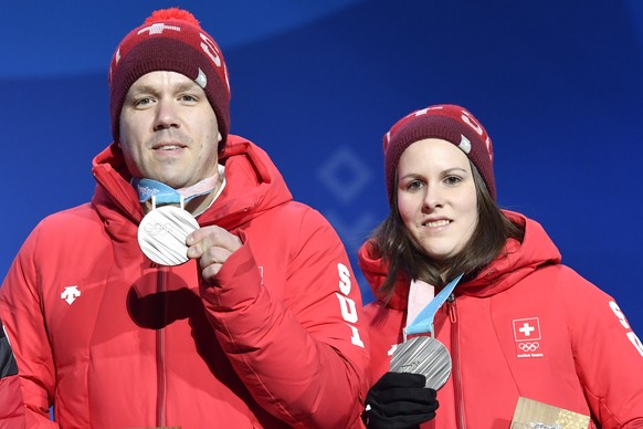 Jenny Perret and Martin Rios of Switzerland react with the silver medal during the victory ceremony on the Medal Plaza for the mixed doubles final curling match at the XXIII Winter Olympics 2018 in Py ...