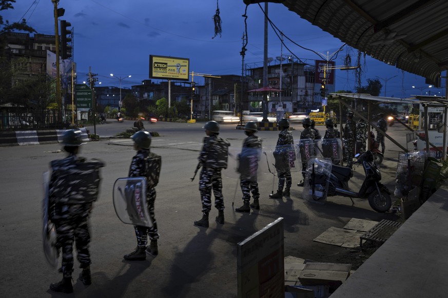 Indian paramilitary soldiers stand guard to enforce curfew in Imphal, capital of the northeastern Indian state of Manipur, Monday, June 19, 2023. Deadly clashes, which have left at least 130 dead by t ...