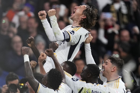 Real Madrid&#039;s Luka Modric celebrates with his teammates after scoring his team&#039;s first goal during the Spanish La Liga soccer match between Real Madrid and Sevilla at the Santiago Bernabeu s ...