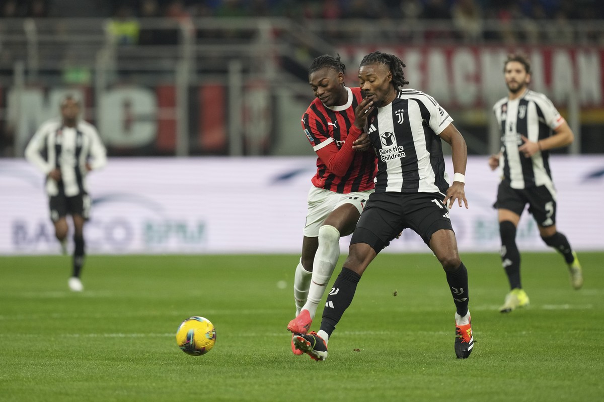 AC Milan's Rafael Leao, left, and Juventus' Khephren Thuram fight for the ball during the Serie A soccer match between AC Milan and Juventus at the San Siro stadium in Milan, Italy, Saturday ...