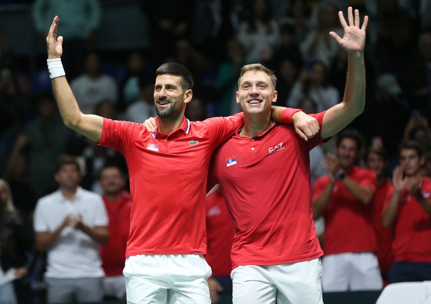 epa11605737 Novak Djokovic and Hamad Medjedovic of Serbia celebrate after winning against Petros Tsitsipas and Aristotelis Thanos of Greece during the Davis cup, World Group I tennis match between Ser ...