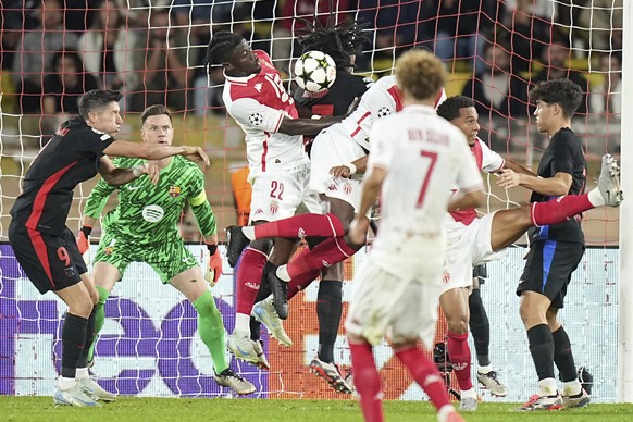 Monaco&#039;s Mohammed Salisu, third left, heads the ball past Barcelona&#039;s Jules Kounde during the Champions League opening phase soccer match between Monaco and Barcelona at the Louis II stadium ...