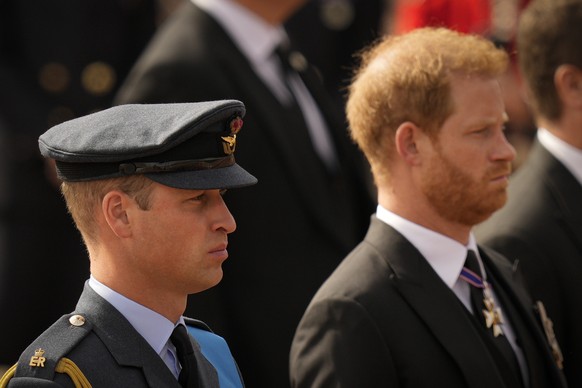 Prince William and Prince Harry follow the coffin of Queen Elizabeth II as it is pulled after her funeral service in Westminster Abbey, in central London Monday Sept. 19, 2022. The Queen, who died age ...