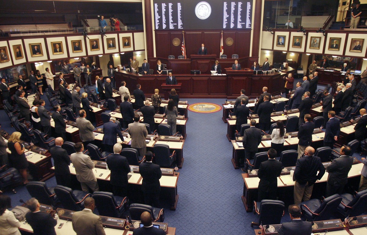 FILE - Members of the House of Representatives rise for prayer at the opening of a special session, Aug. 7, 2014, at the Capitol in Tallahassee, Fla. A stripper and the strip club where she worked hav ...