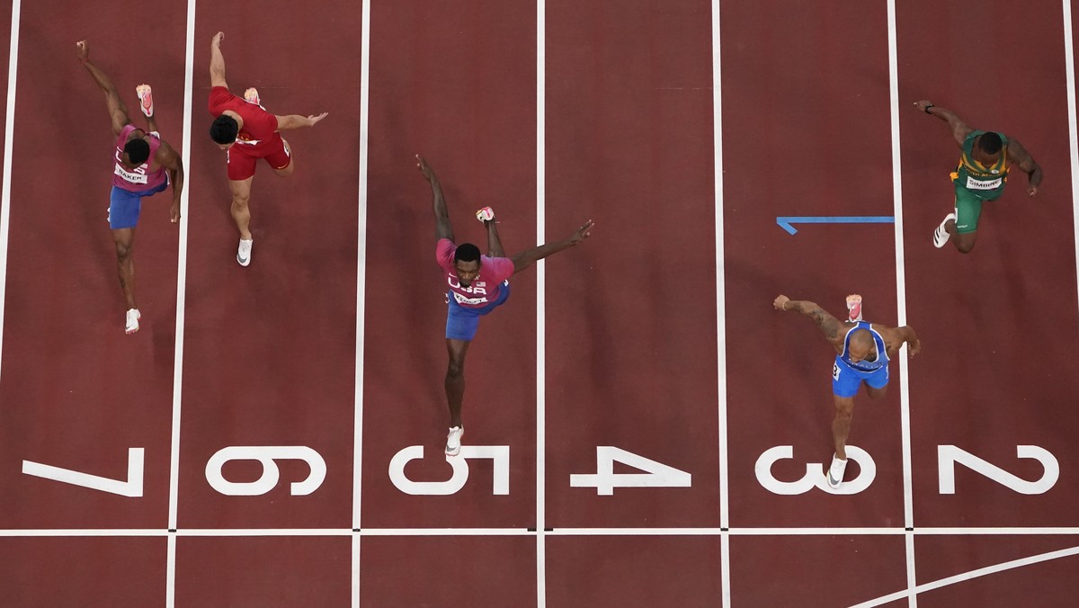 Lamont Jacobs, of Italy, beats Fred Kerley, of United States, during the finals in the men's 100-meter at the 2020 Summer Olympics, Sunday, Aug. 1, 2021, in Tokyo. (AP Photo/Morry Gash)
